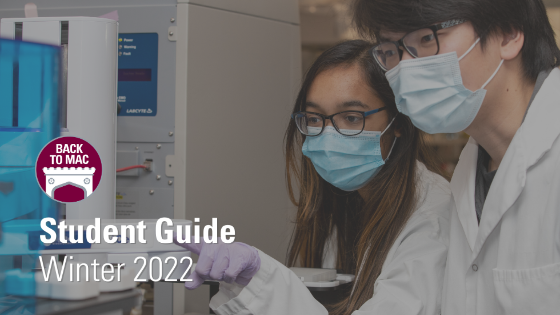 Two masked students in lab coats collaborate on a project, examining a machine, with 'Student guide winter 2022' text.