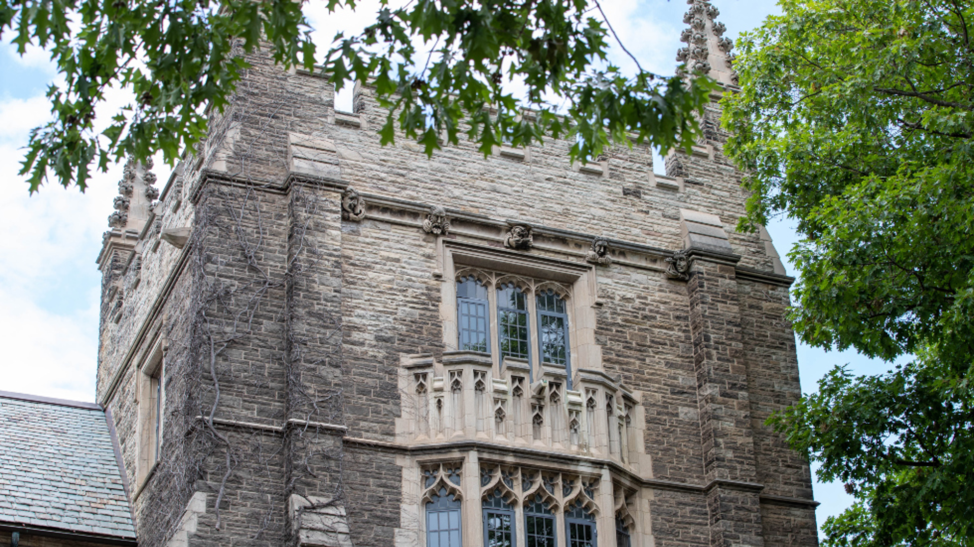 A tall view of Hamilton Hall at McMaster University, showcasing its impressive architectural design against the sky.