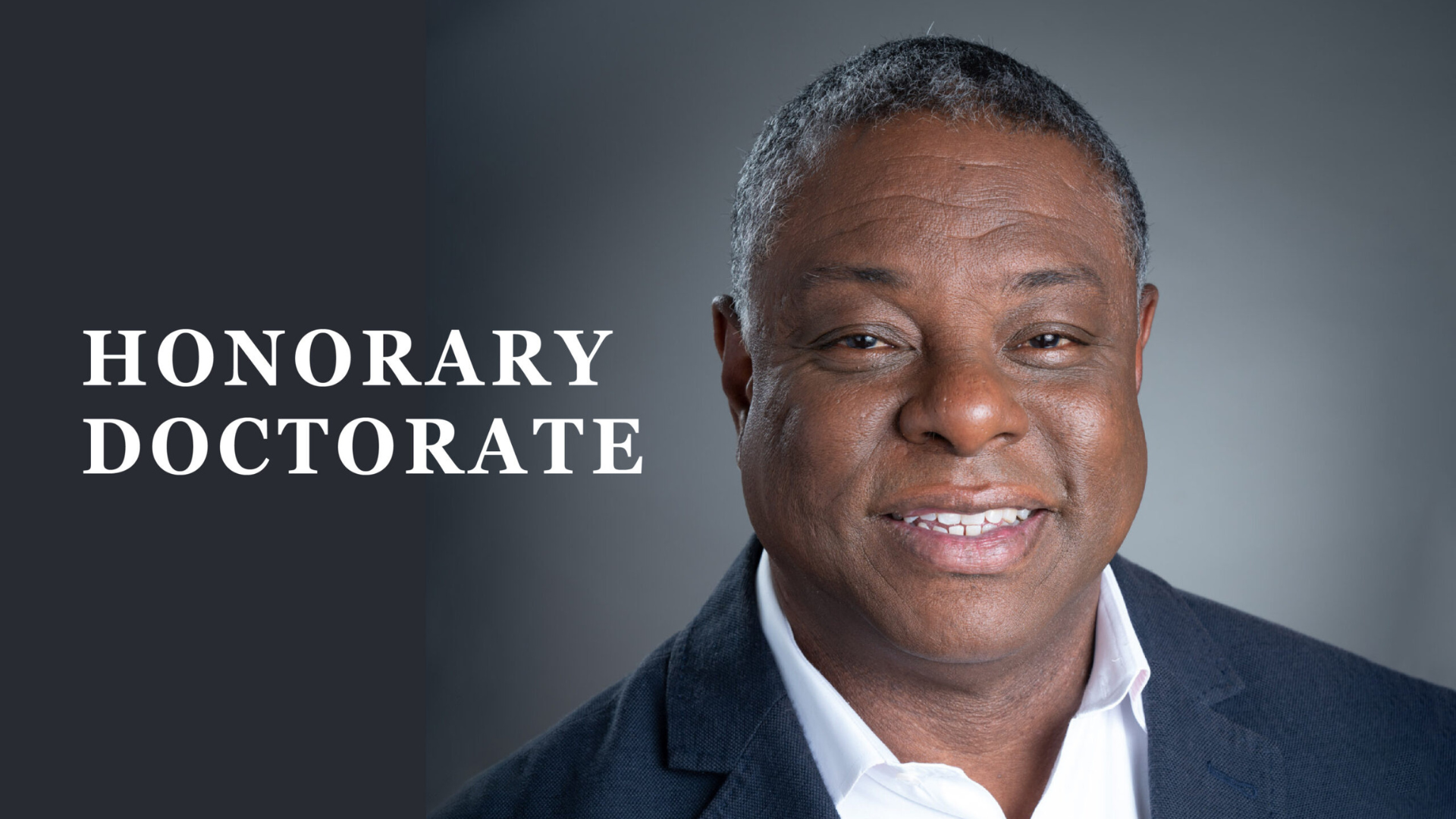 Wayne Purboo smiles in a dark blue suit beside the text 'Honorary Doctorate'.