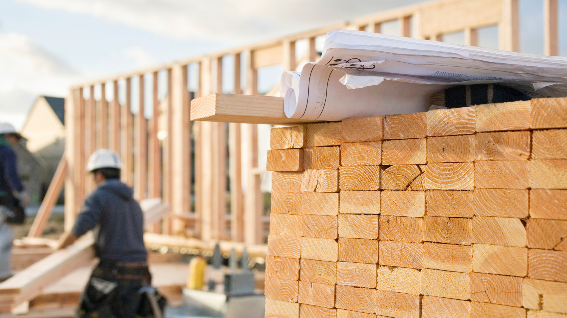 Construction workers engaged in house construction, emphasizing the skilled trades gap that threatens housing solutions.