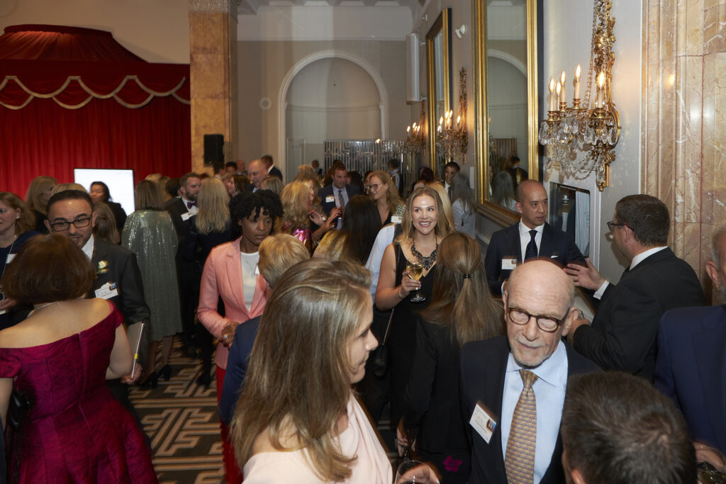 Attendees mingling and networking at a formal event reception, highlighting the atmosphere of connection and engagement.