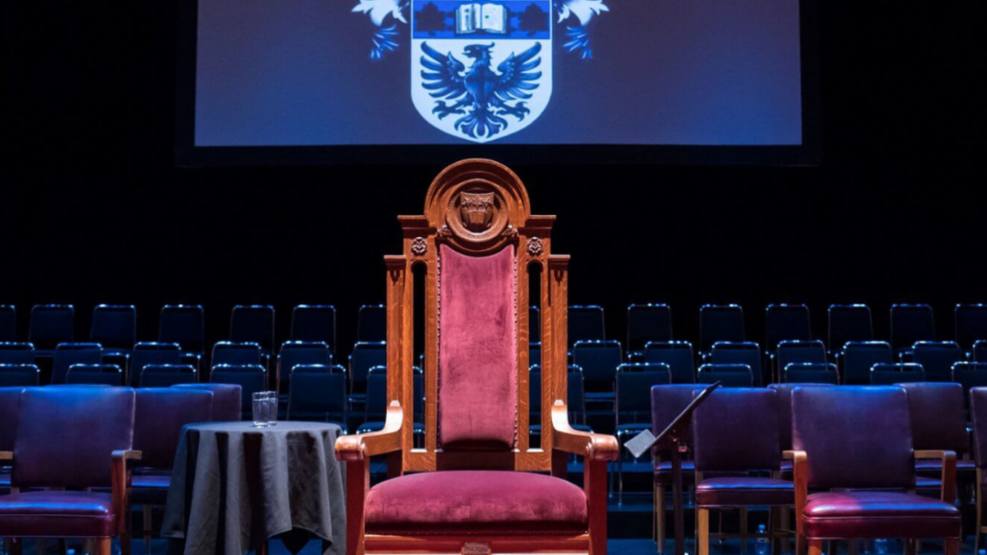 An ornate royal throne within a royal theatre.