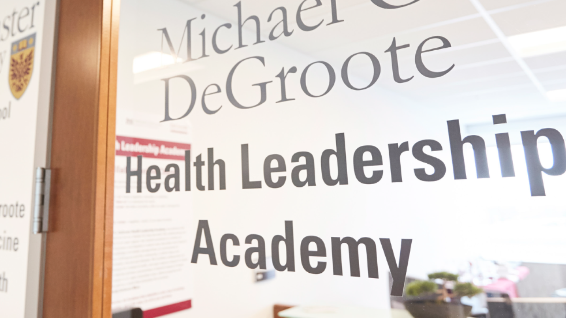 Entrance of the DeGroote Health Leadership Academy, showcasing a modern building with clear signage.