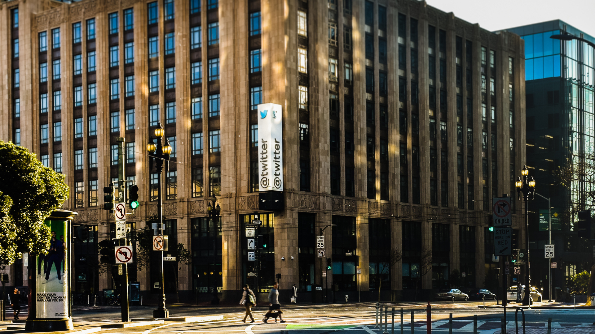 A large building featuring a prominent sign, identified as the headquarters of X, formerly known as Twitter.