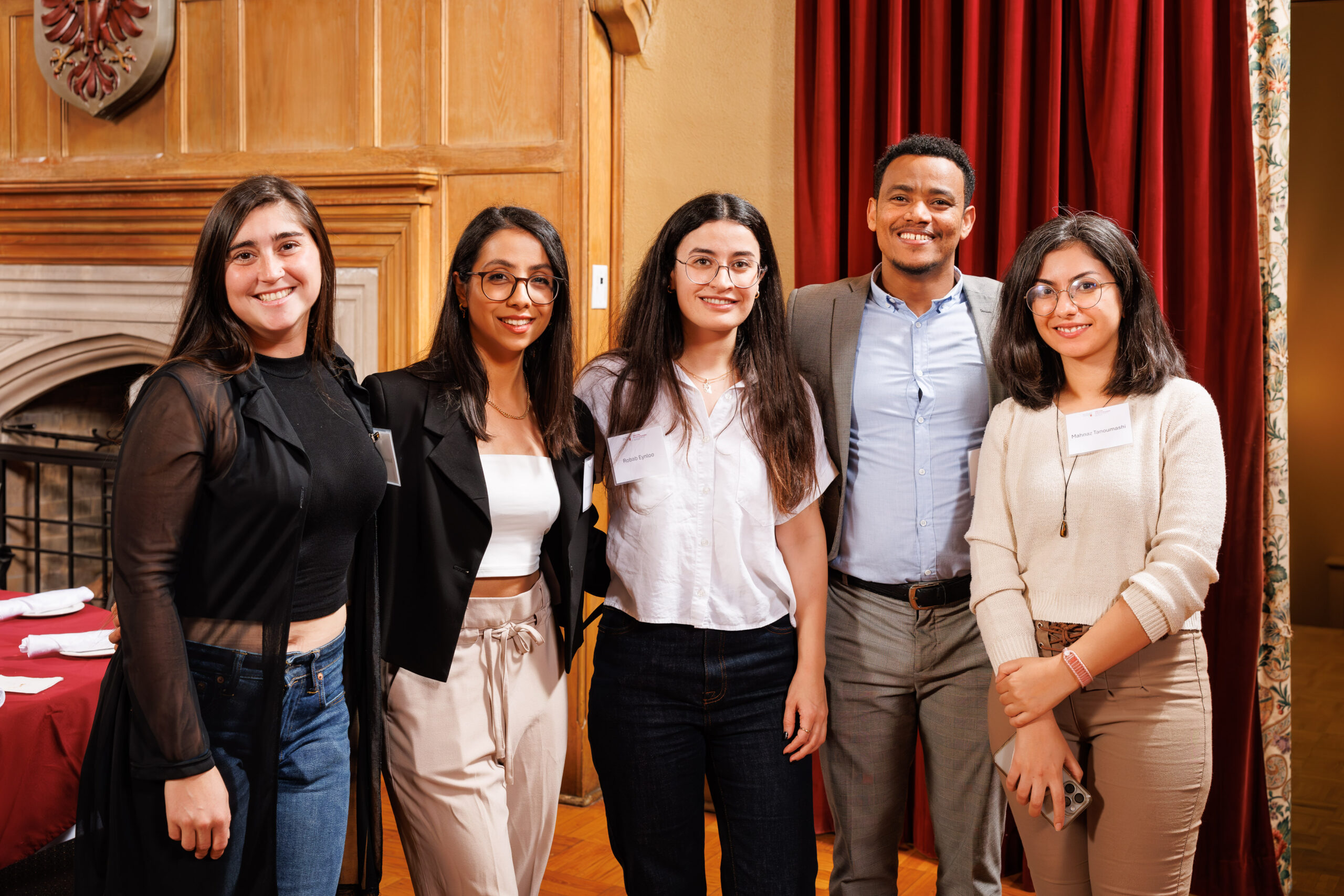  group of DeGroote PhD students smiling together, capturing a joyful moment.