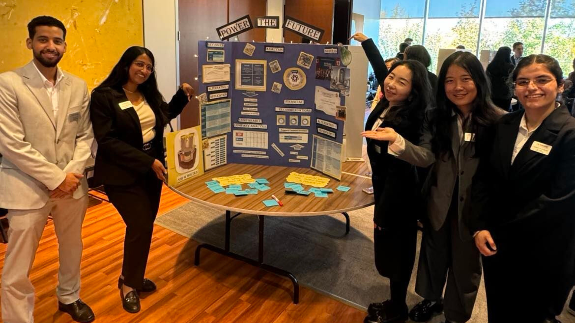 Group of MBA students showing their poster presentation.