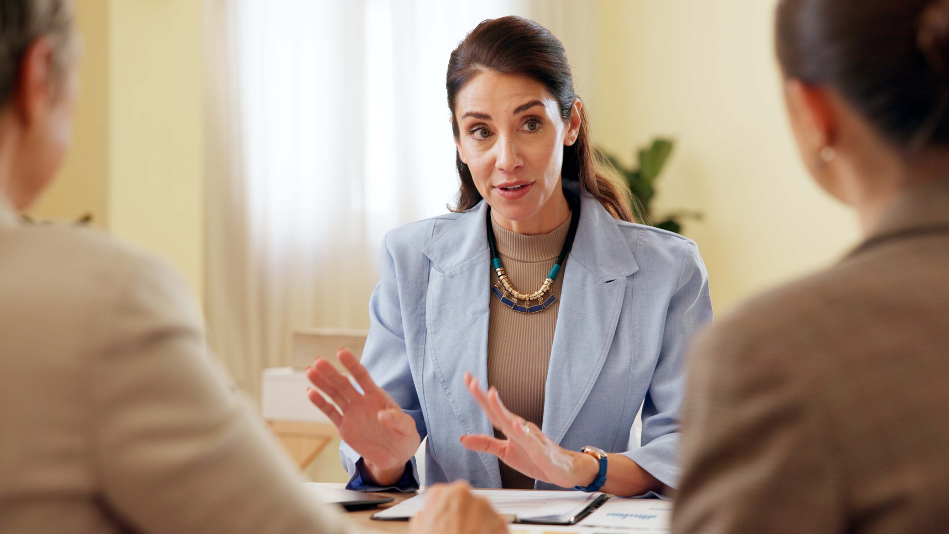 woman has a serious conversation with two colleagues.