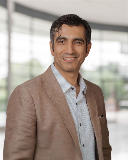 Headshot of Amir Akbari, smiling.