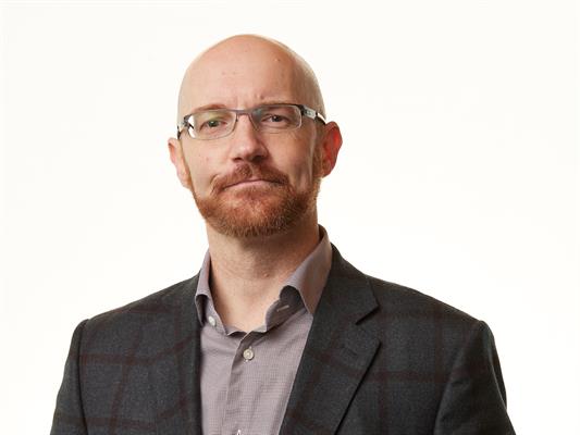 Headshot of Neil Barr, smiling.