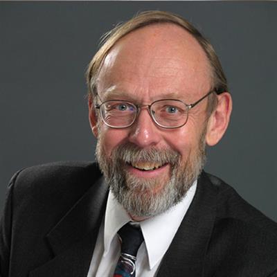 Headshot of Trevor William Chamberlain, smiling.