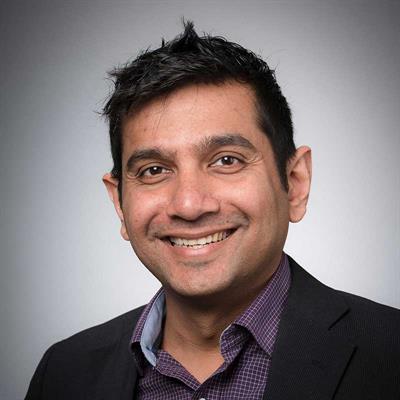 Headshot of Aadil Merali Juma, smiling.