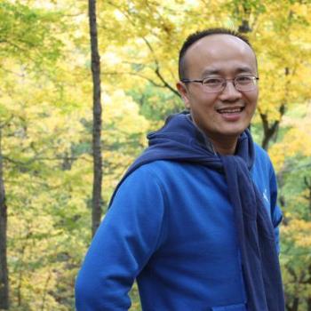 Headshot of Kai Huang, smiling.