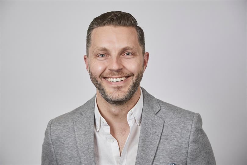 Headshot of Shane Saunderson, smiling.