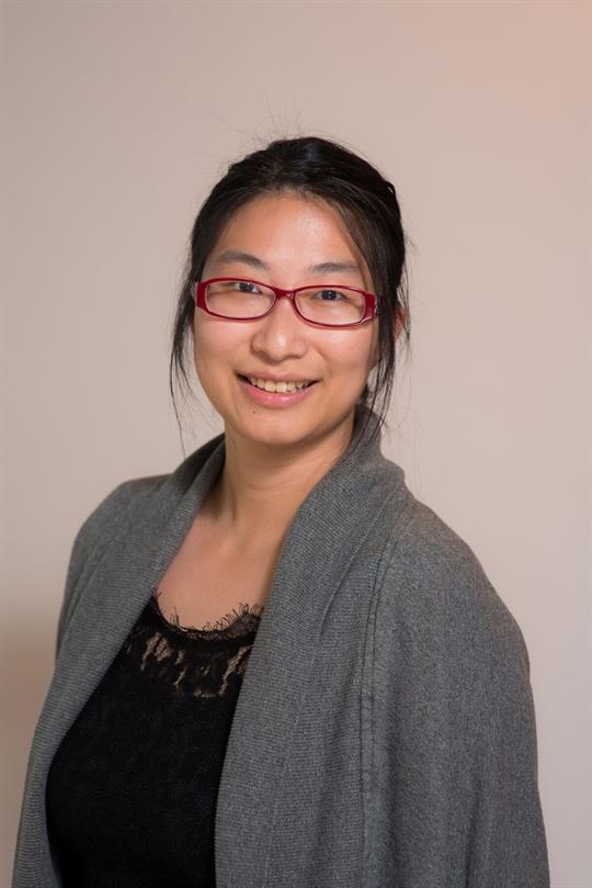 Headshot of Iris Wang, smiling.