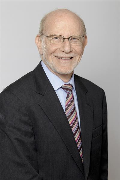 Headshot of Leonard Waverman, smiling.