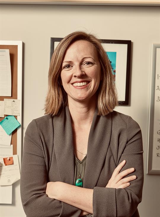 Headshot of Dr. Erin Reid, smiling.