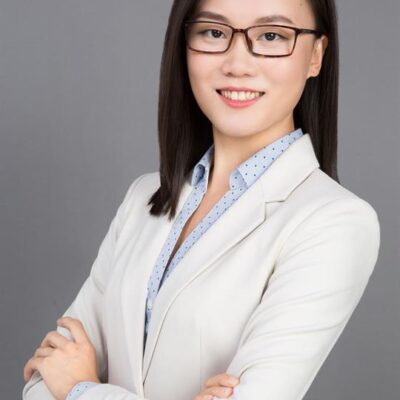 Headshot of Dr. Yingnan Zhao, a smiling Asian woman wearing glasses and a white suit jacket.
