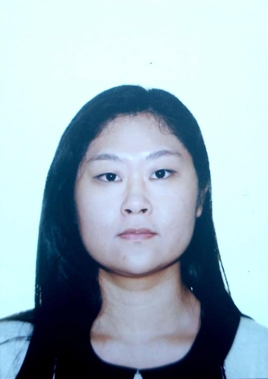 Headshot of Rui Duan, a smiling woman with dark long hair, wearing a light colour blouse.