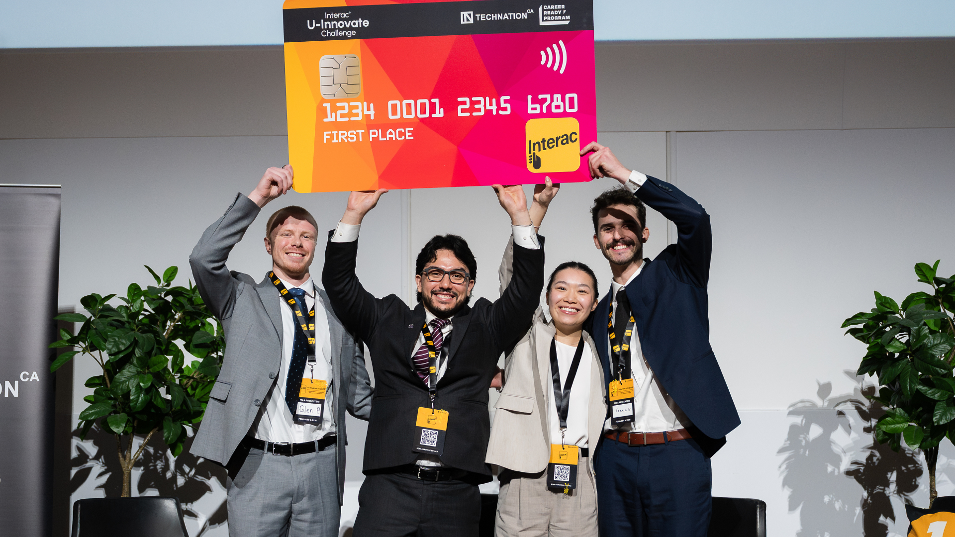 Winning team holding the first-place sign and smiling.