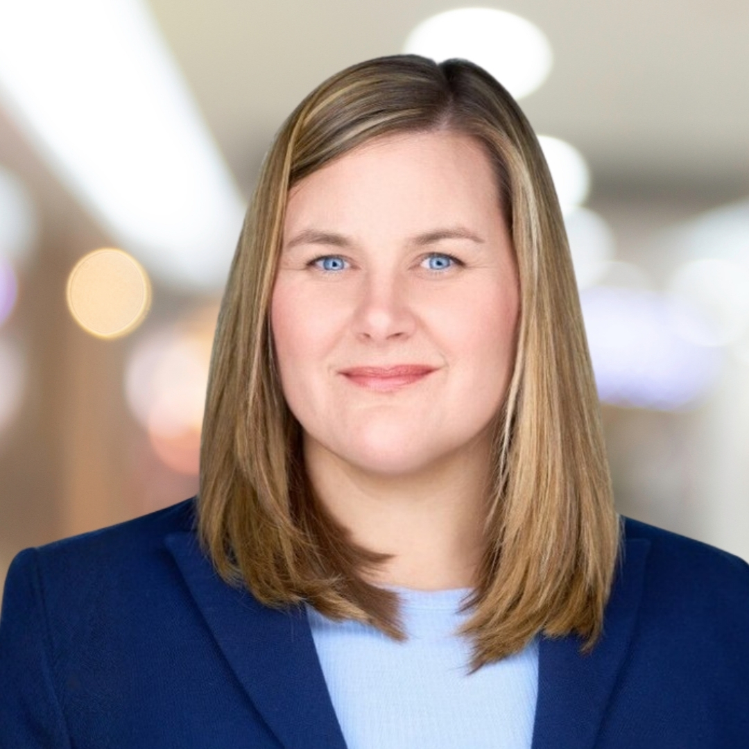 Headshot of Amanda Custodio, smiling woman with short straighter hair, wearing blue blazer.
