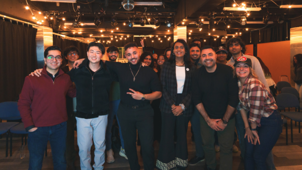 Group of individuals from diverse backgrounds posed together for a photo.