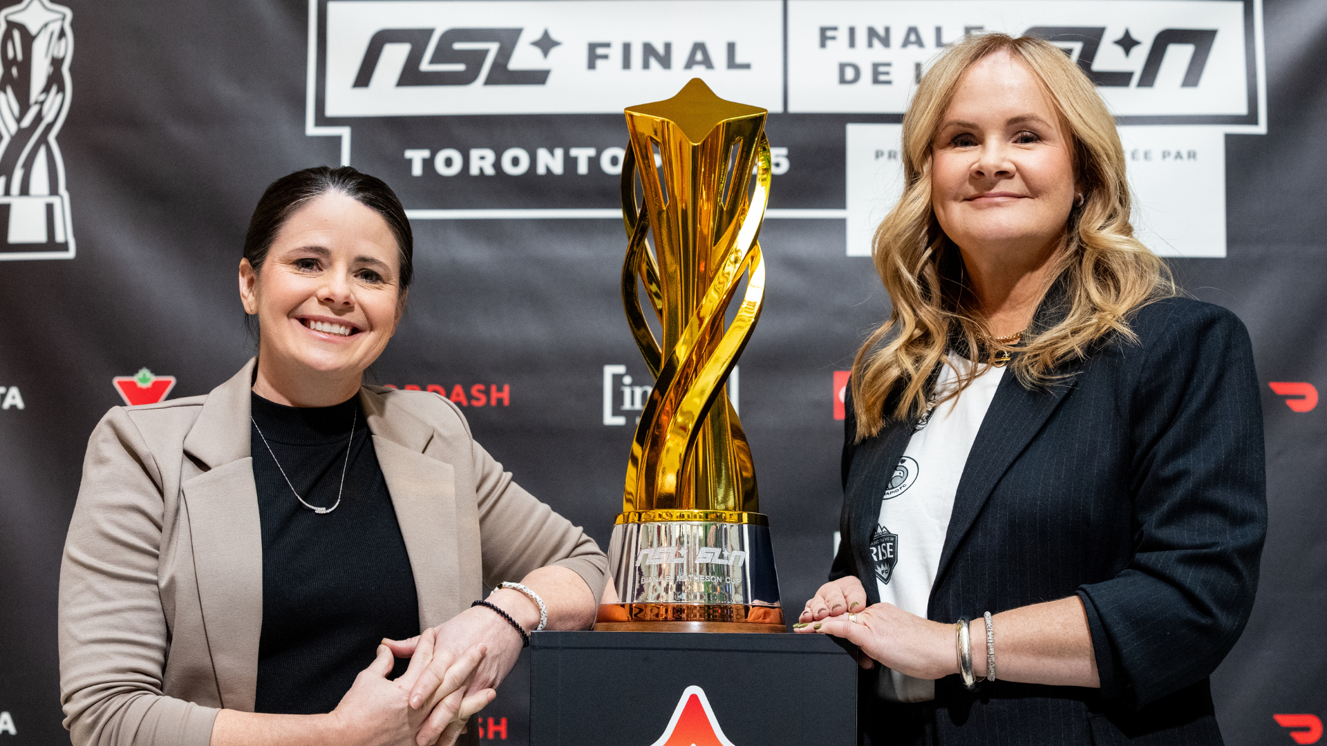 Diana Matheson and Christina Litz pose with the Northern Super League trophy. Photo credit: NSL/SLN