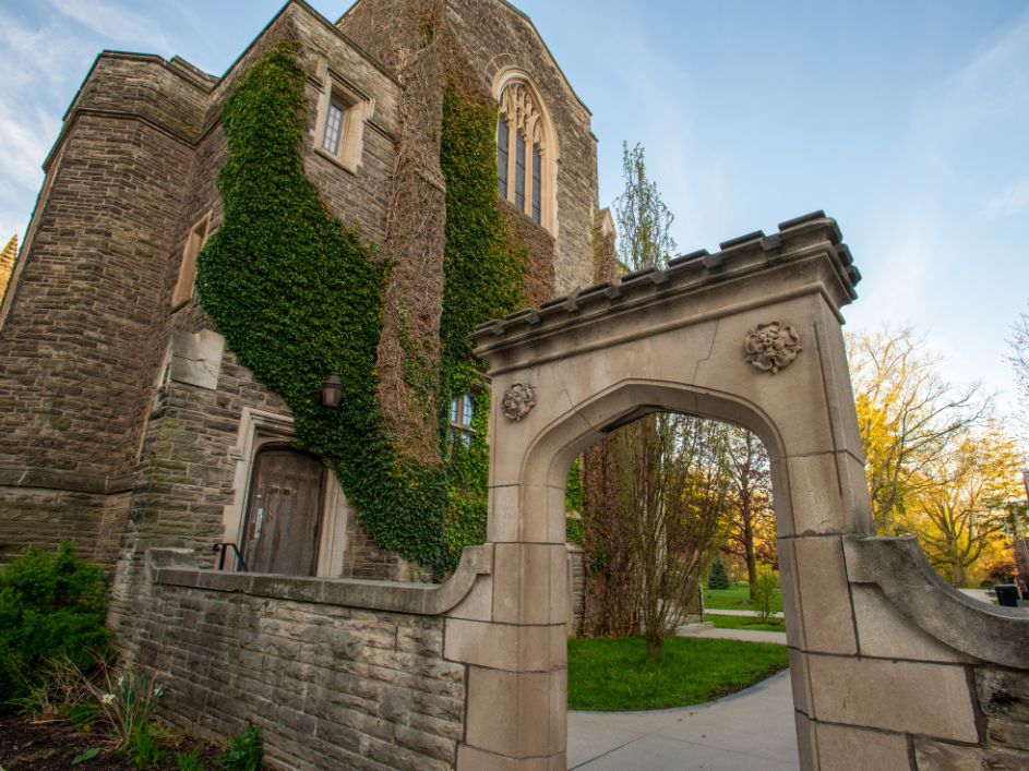 The small archway on McMaster's main campus, with part of University Hall in the background
