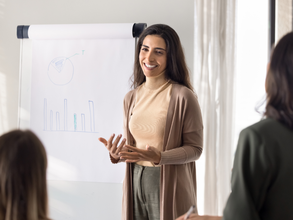 Smiling woman standing in front of a chart