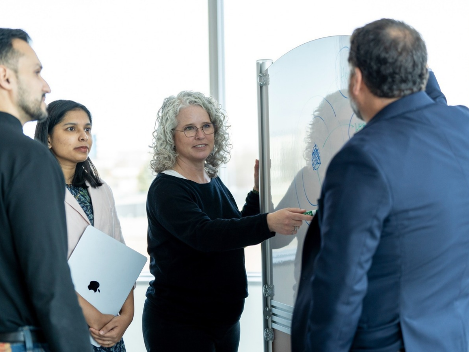 People working together around a whiteboard